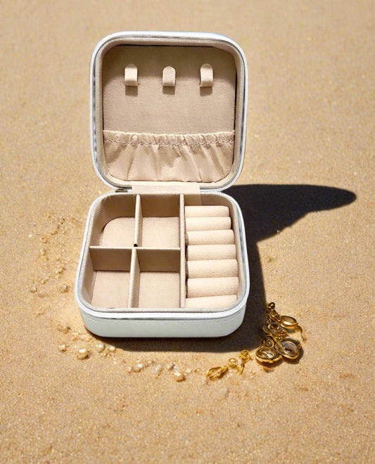 Jewelry box with compartments on a sandy surface